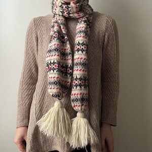 Aris cream, black, and red knit scarf with tassels